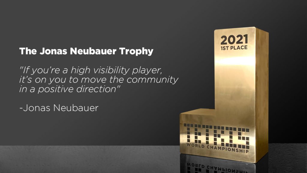 Image of a golden J shaped trophy with the text 'TETRIS World Championship.' Next to the trophy is text that reads: 'If you're a high visibility player, it's on you to move the community in a positive direction - Joseph Neubauer.'